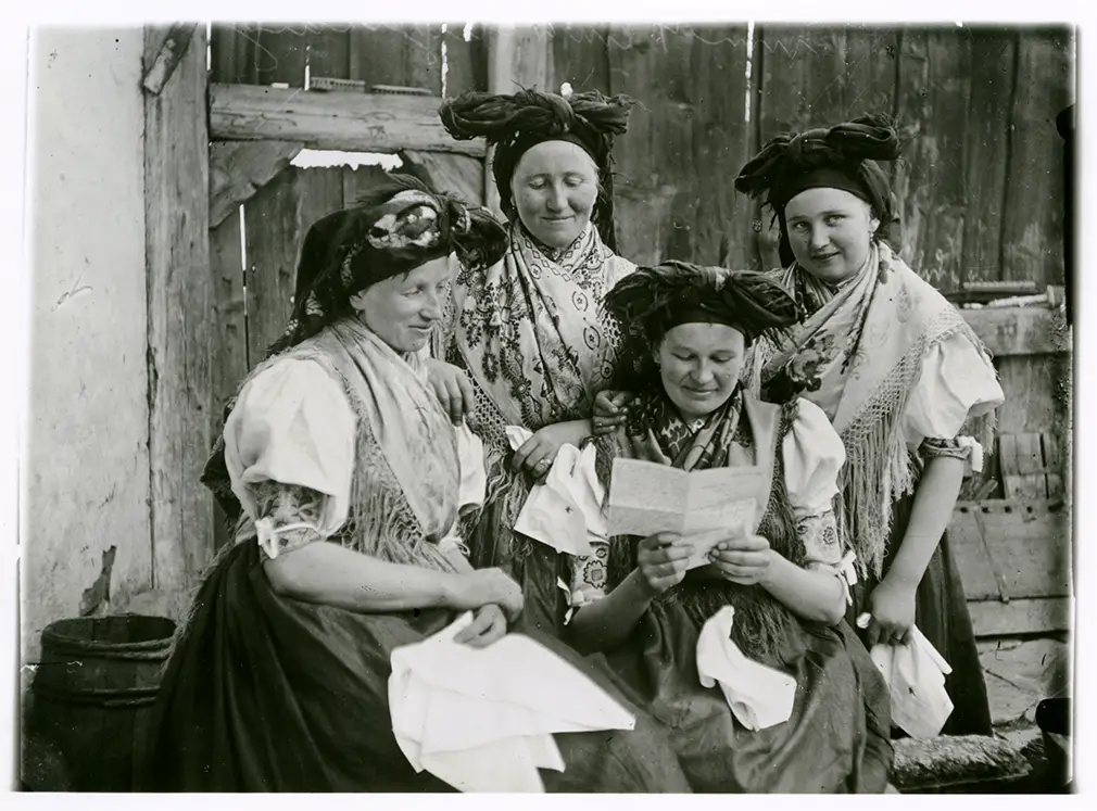 4 Frauen mit Trachten lesen einen Brief.